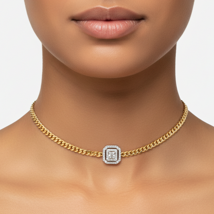 Gold chain necklace with a diamond clasp on a model against a neutral background