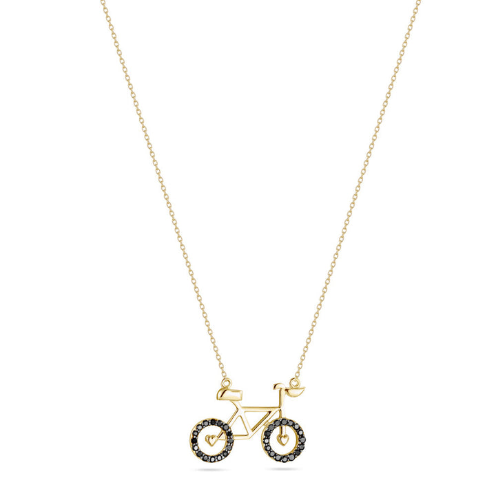 A yellow gold necklace with a bicycle shaped pendant adorned with colored stones